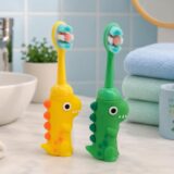 Tinsy Toddler Toothbrush with Travel Case – Cartoon Dinosaur Handle with Anti-Slip Grip, Extra-Soft Bristles for Gentle Cleaning & Sensitive Gums (Pastel Yellow & Seafoam Green) - Pack of 2